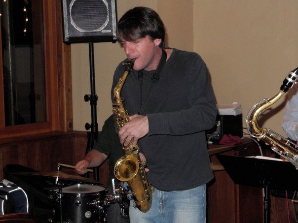 Dan soloing on saxophone, blue light