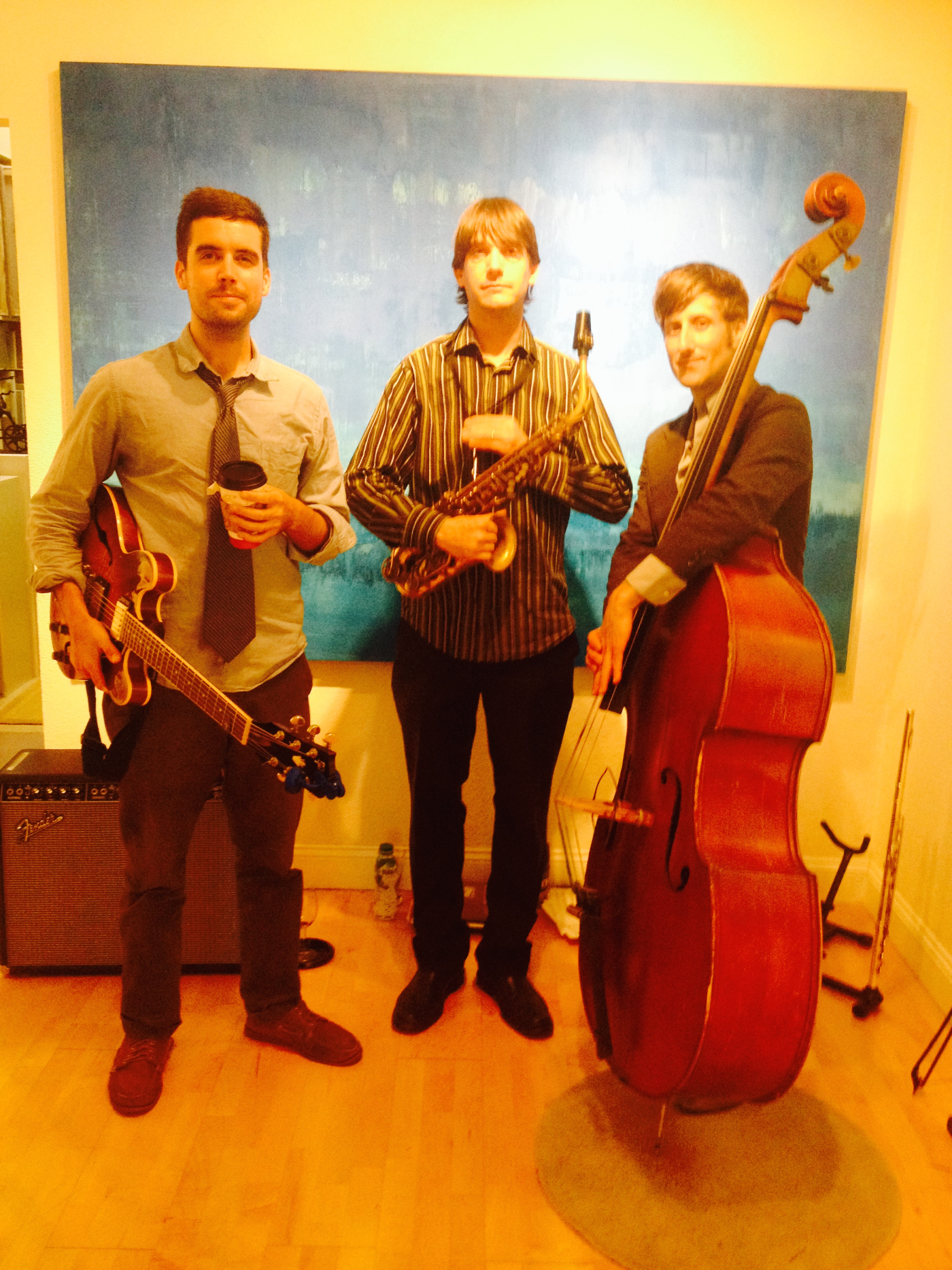 The trio before a blue painting